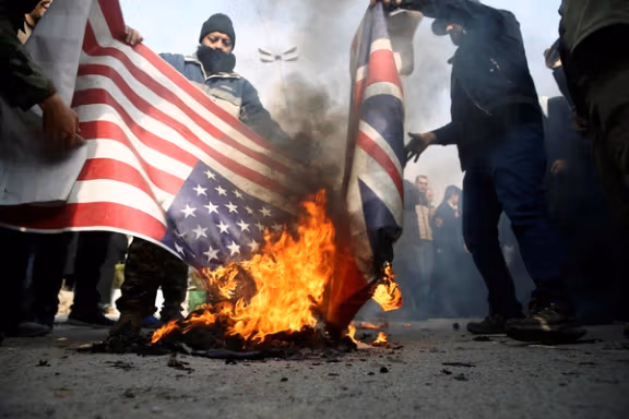 Demonstrators burn US and UK flags in Tehran (file photo)