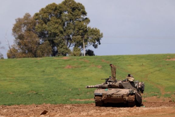 Israeli soldiers stand atop of a tank, amid the ongoing conflict between Israel and the Palestinian Islamist group Hamas, near the border with North Gaza, Israel January 31, 2024.