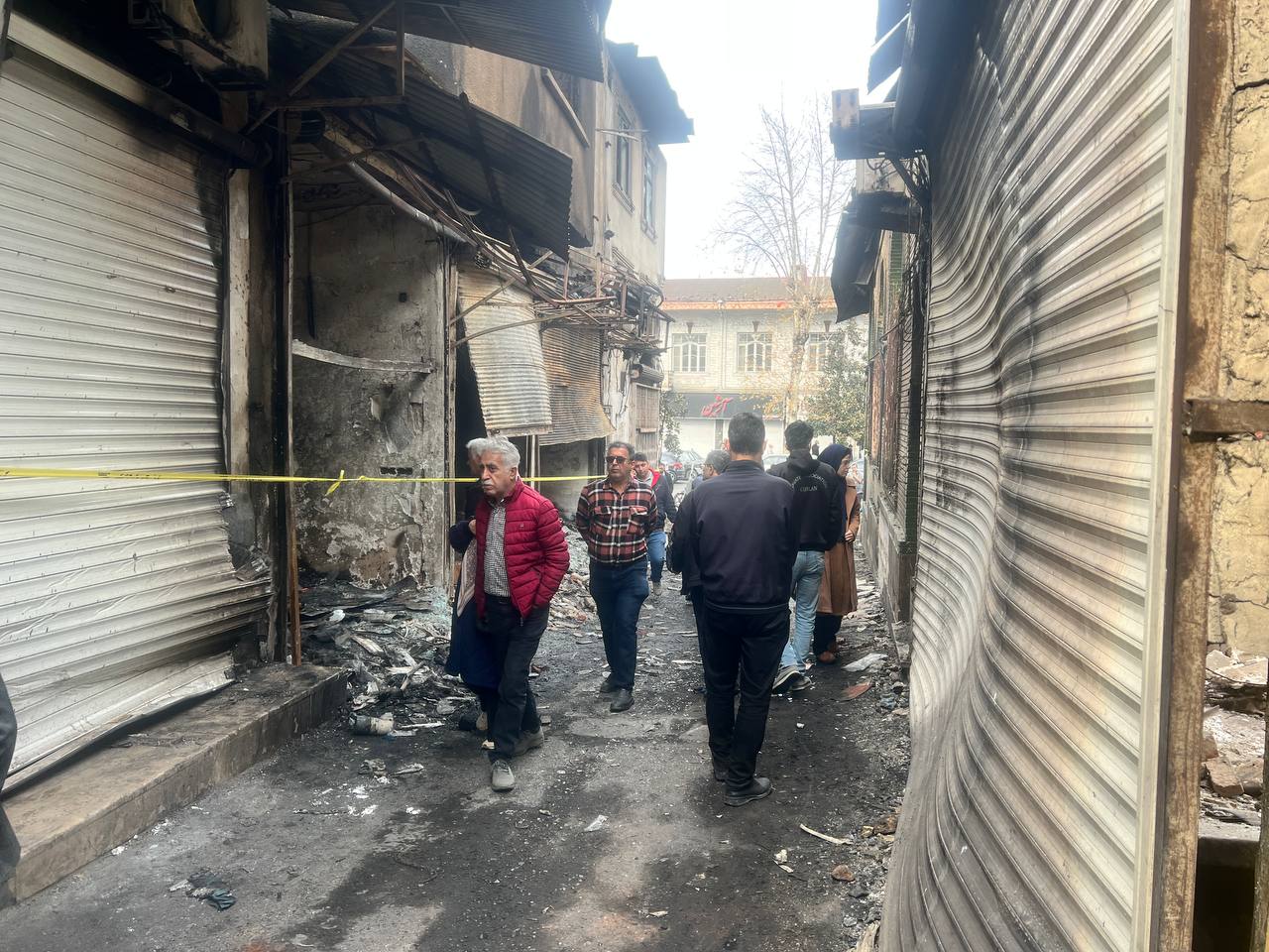 People walking at Rasht bazaar the day after the fire in January  