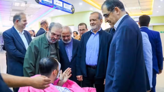 Iran's President Masoud Pezeshkian visits one of the victims injured by pager explosions across Lebanon, in a hospital in Tehran, Iran, September 20, 2024.