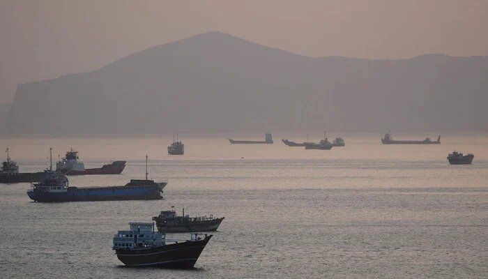 Cargo vessels transit the Strait of Hormuz