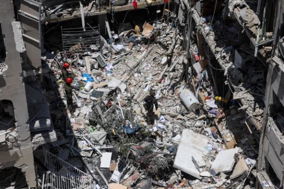 Rescue personnel work at an impact site following a missile attack from Iran, in Bat Yam, Israel, June 15, 2025.