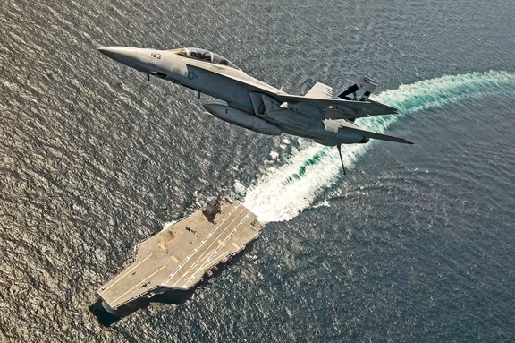 A US Navy F/A-18F Super Hornet jet approaches the USS Gerald R. Ford to make the first landing in the Atlantic Ocean, August 1, 2017
