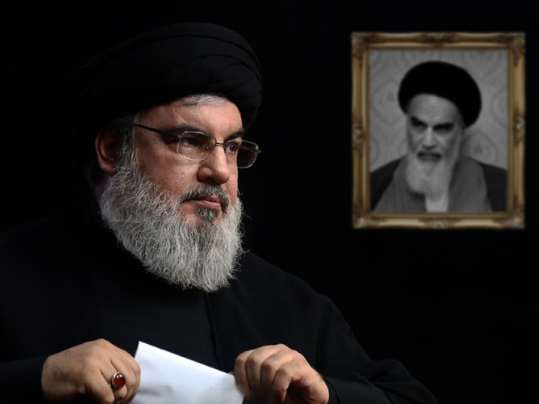 Hezbollah leader Hassan Nasrallah, with a portrait of Ayatollah Ruhollah Khomeni