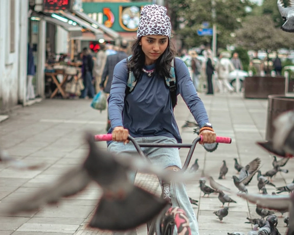 A young Iranian woman rides her bike in the northern city of Rasht, Iran, May 2025