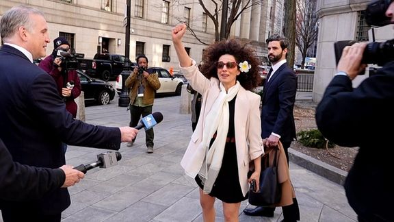 Iranian-American activist raised a fisted arm in the air outside a Manhattan courtroom Tuesday following her testimony in court.