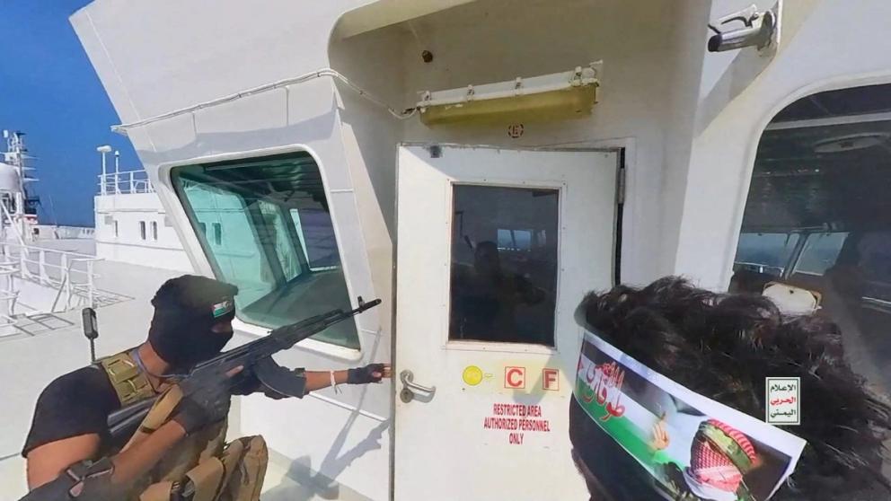 Houthi fighters open the door of the cockpit on the ship's deck in the Red Sea in this photo released November 20, 2023. 