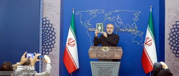 Iranian Foreign Ministry spokesman Nasser Kanaani holding a copy of the Quran during his press conference on July 24, 2023