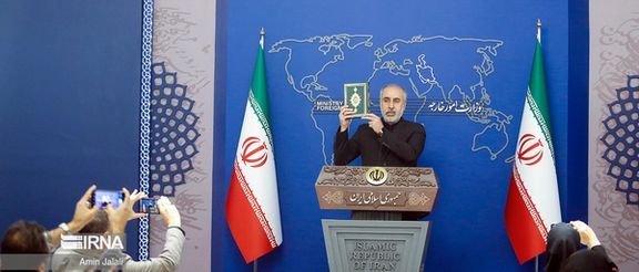 Iranian Foreign Ministry spokesman Nasser Kanaani holding a copy of the Quran during his press conference on July 24, 2023