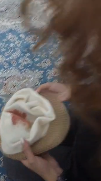 Screenshot of Iranian protester describing being hit on the head and bloodied by baton from Iran's security forces.