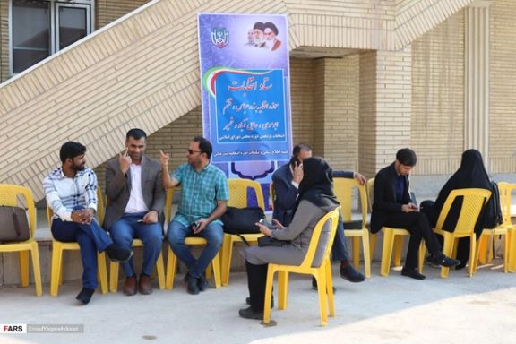 Iranians wait at the office to register the candidates for the previous round of Iran’s parliamentary elections in the city of BandarAbbas, December 2019