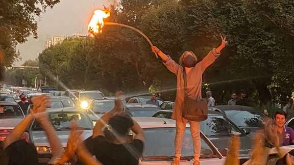 The first day of large anti-regime protests in Iran, as a young woman burns her headscarf in central Tehran. Sept. 19, 2022