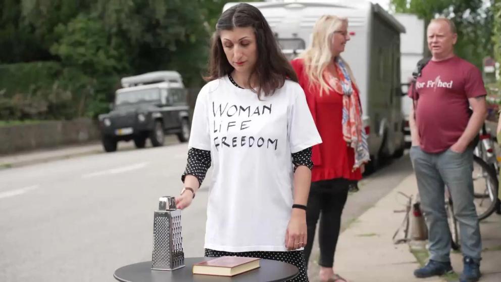 Iranian-Danish artist Firoozeh Bazrafkan shredded a copy of the Quran outside the Iranian embassy in the Danish capital Copenhagen on August 5, 2023.  