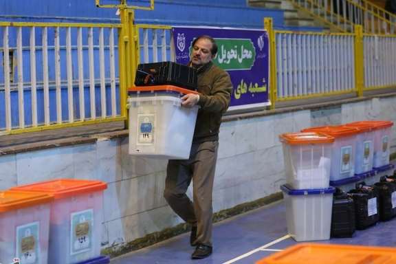 An Iranian man preparing ballot boxes for the March 1 elections