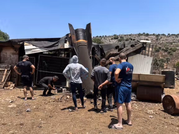 People look at an apparent remains of a ballistic missile following missile attack by Iran on Israel, in northern Israel, June 24, 2025.