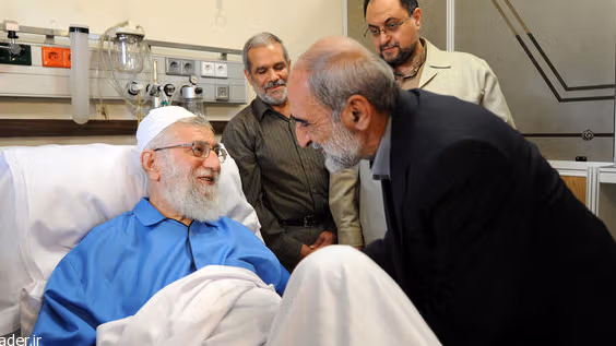 Hossein Shariatmadari, the hardline editor of the Kayhan newspaper, visiting Supreme Leader Ali Khamenei (left) at hospital in 2014