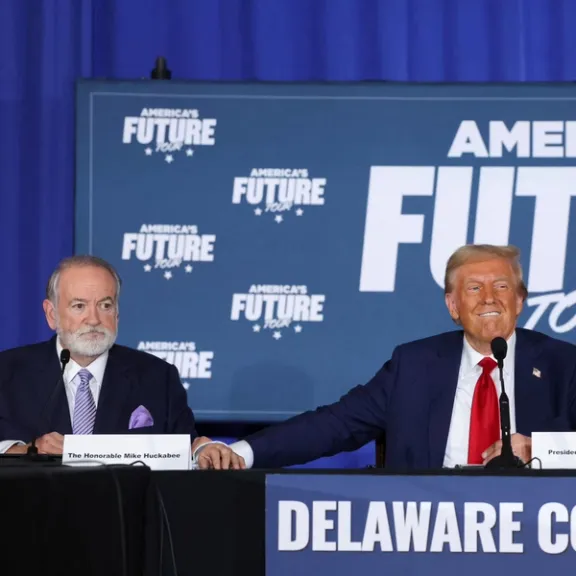Mike Huckabee looks on as Republican presidential nominee and former U.S. President Donald Trump reacts during a campaign event at the Drexelbrook Catering and Event Center, in Drexel Hill, Pennsylvania, U.S., October 29, 2024.