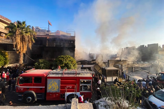Smoke rises as people gather at a damaged site after what Syrian state news agency said was an Israeli strike in Damascus suburb of Mazzeh, Syria November 14, 2024.