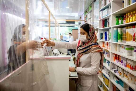 A female pharmacy worker with hijab in Tehran