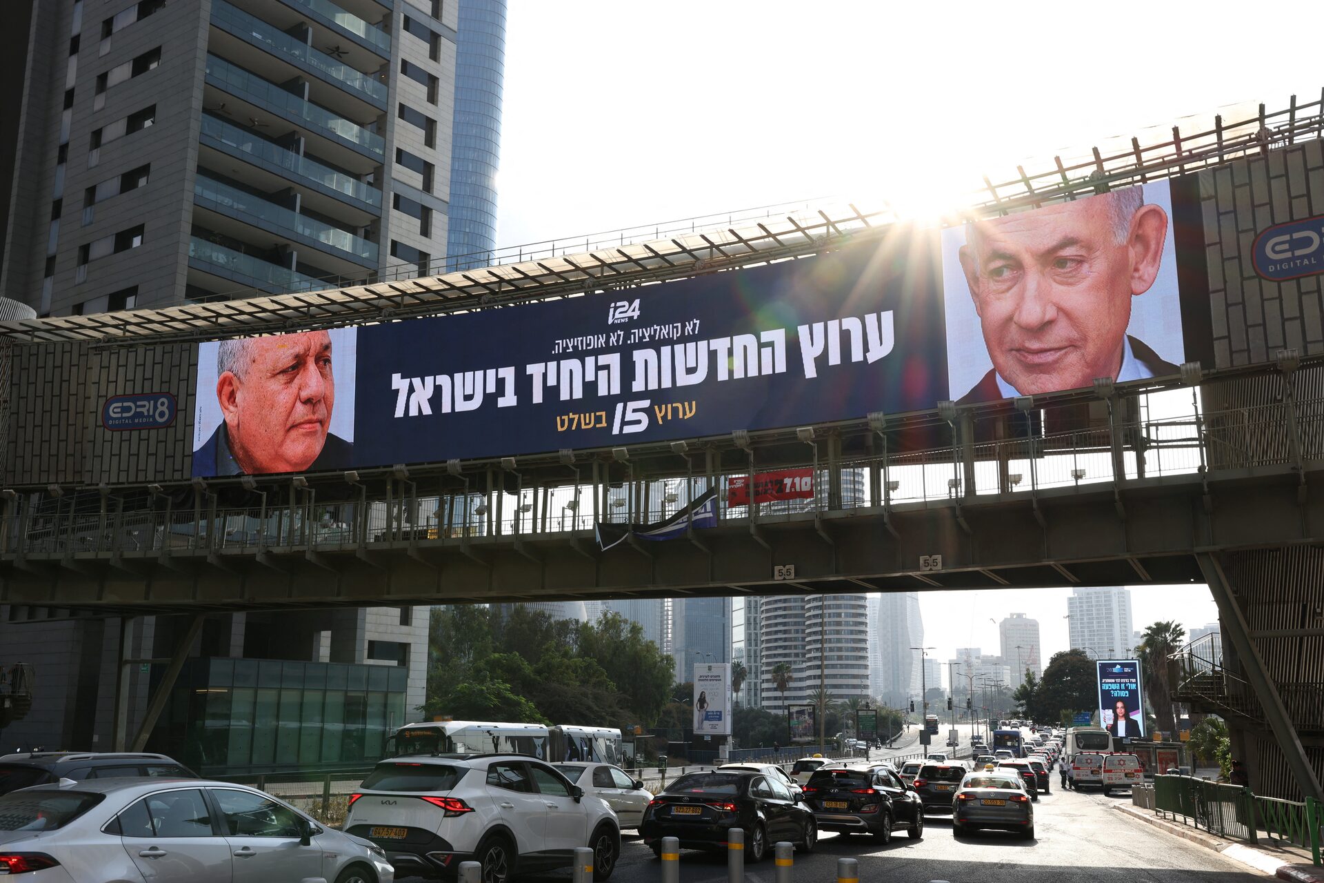 An advert for an Israeli television channel that will broadcast Israel's election coverage features Israeli Prime Minister Benjamin Netanyahu and former Israeli military chief Gadi Eisenkot, leader of the Yashar party, ahead of Israel's national election, on a bridge in Tel Aviv, Israel, October 21, 2026. 