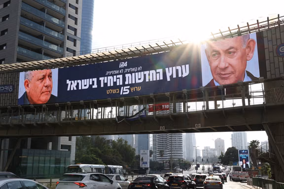 An advert for an Israeli television channel that will broadcast Israel's election coverage features Israeli Prime Minister Benjamin Netanyahu and former Israeli military chief Gadi Eisenkot, leader of the Yashar party, ahead of Israel's national election, on a bridge in Tel Aviv, Israel, October 21, 2026.