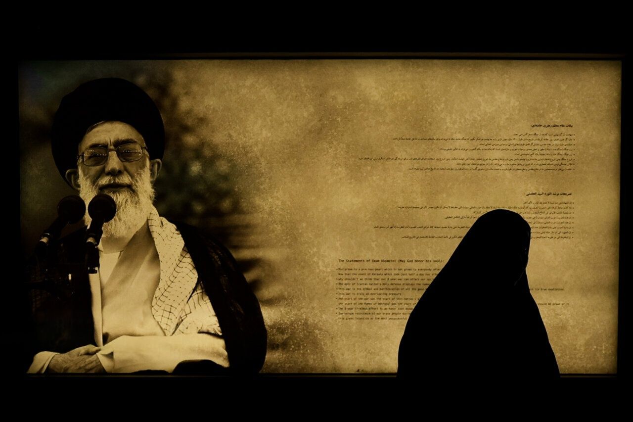 A woman passes by an image of Iran’s Supreme Leader Ali Khamenei at an exhibition commemorating the Iran-Iraq war, Tehran, Iran, September 22, 2025