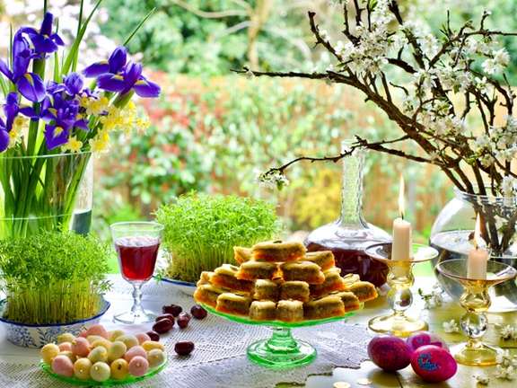 Nowrouz spread with sprouted greens, coins, and sweets