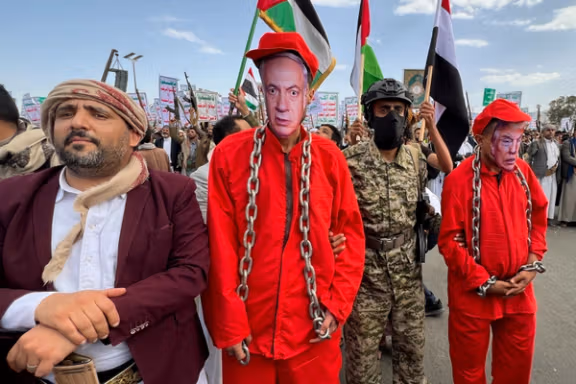 Yemeni demonstrators wear masks depicting US President Donald Trump and Israeli Prime Minister Benjamin Netanyahu, as Houthi supporters rally in Sanaa, May 9, 2025.