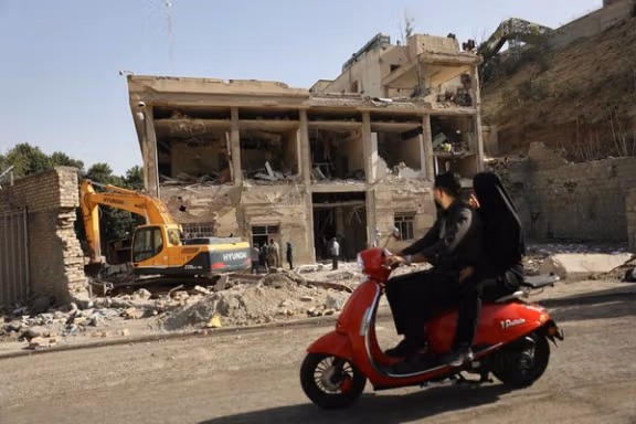 People survey the damage at Tehran's Evin Prison (June 2025)
