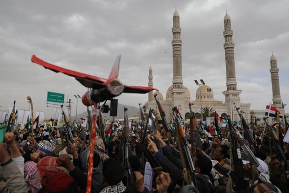 People hold up weapons and a mock drone, as protesters, mainly Houthi supporters, rally to show support for the Palestinians in the Gaza Strip, in Sanaa, Yemen March 1, 2024.