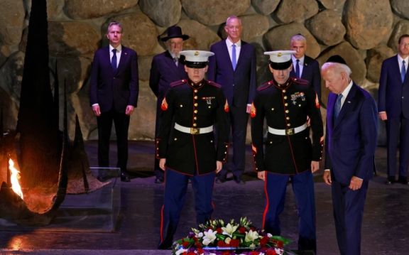 US President Joe Biden lays a wreath of flowers as Secretary of State Antony Blinken, Holocaust survivor and Chairman of the Yad Vashem Council Rabbi Israel Meir Lau, Israeli Defence Minister Benny Gantz, Israel's caretaker Prime Minister Yair Lapid and Israel's President Isaac Herzog look on at the Hall of Remembrance of the Yad Vashem Holocaust Memorial museum in Jerusalem, July 13, 2022.
