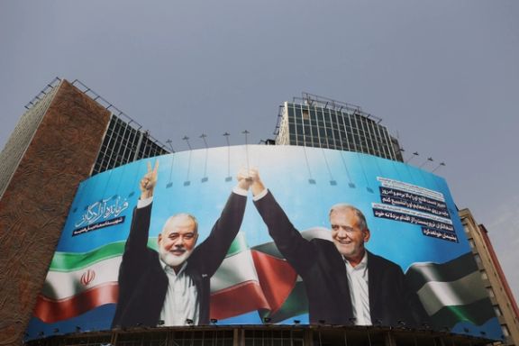 A billboard with a picture of assassinated Hamas chief Ismail Haniyeh and Iran's President, Masoud Pezeshkian, is displayed on a building in a street in Tehran, Iran, August 1, 2024.