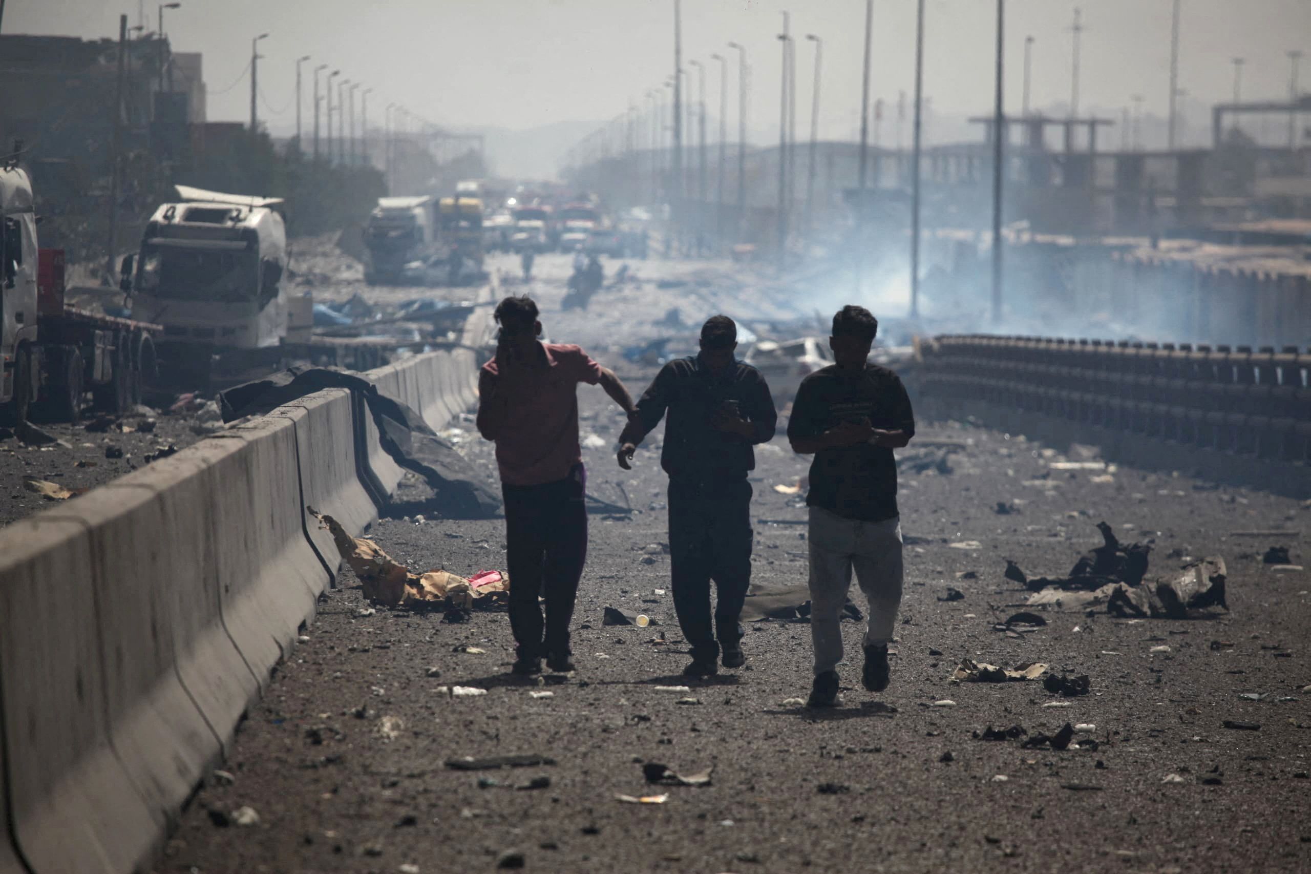 People walk after an explosion at the Shahid Rajaee port in Bandar Abbas, Iran, April 26, 2025. 