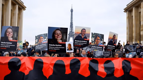 Supporters and relatives of French citizens detained in Iran, Cecile Kohler, Benjamin Briere, Jacques Paris and Fariba Adelkhah, gather in front of the Eiffel Tower during a rally demanding their release, in Paris, France, January 28, 2023.