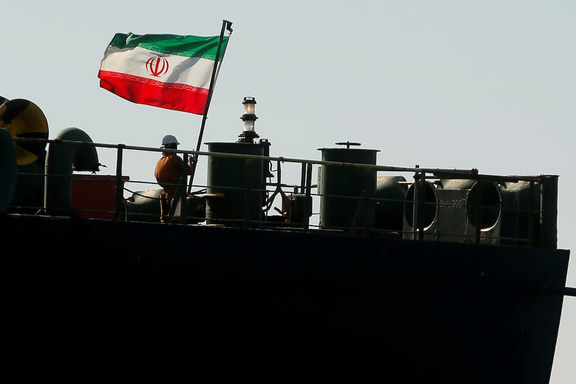 A crew member raises the Iranian flag on Iranian oil tanker Adrian Darya 1, previously named Grace 1, in the Strait of Gibraltar, Spain, August 18, 2019.
