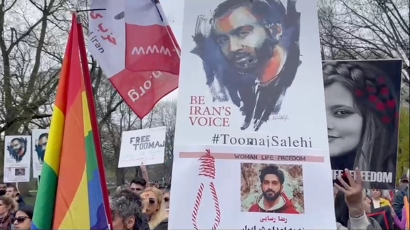A poster with Toomaj's photo in a protest in Toronto
