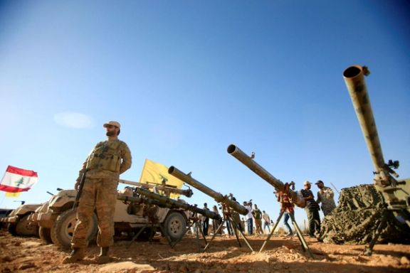 A Hezbollah fighter stands in front of anti-tank artillery at Juroud Arsal, the Syria-Lebanon border, July 29, 2017.