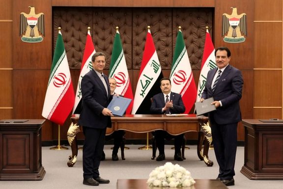 Iranian President Masoud Pezeshkian and Iraqi Prime Minister Mohammed Shia al-Sudani react as Chairman of the Baghdad Chamber of Commerce, Firas Rasool exchanges a Memorandum of Understanding with the Iranian Minister of Trade during the signing ceremony of Memoranda of Understanding between Iraq and Iran at the government palace in Baghdad, Iraq, 11 September 2024.