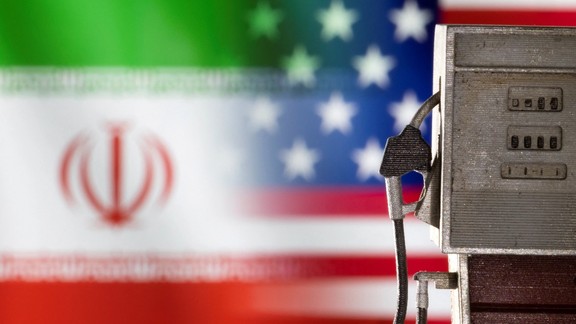 Model of petrol pump is seen in front of US and Iran flag colors in this illustration taken March 25, 2022.