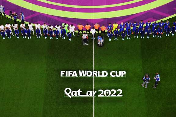 Iranian and US teams and match officials line up before their World Cup match at Doha’s Al Thumama Stadium, Qatar, on November 29, 2022