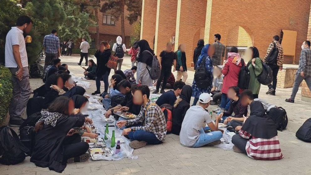 Students eating lunch outside the cafeteria in Sharif University on October 24m 2022