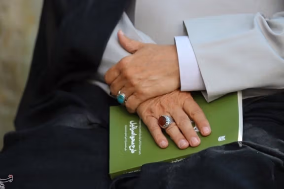 A cleric holds a copy of the new book ‘Israel annihilation plan’ while attending an unveiling ceremony in the holy city of Qom, Oct. 14, 2025.