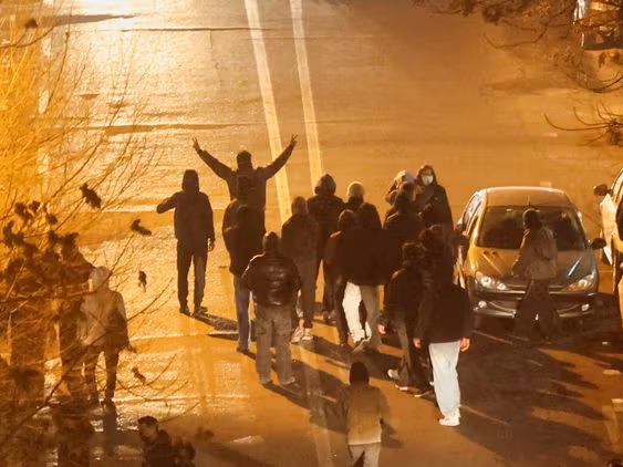 Iranian demonstrators gather in a street during a protest over the collapse of the currency's value, in Tehran, Iran, January 8, 2026.