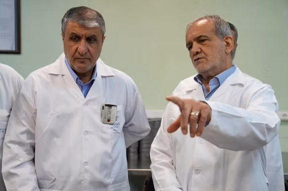 Iranian President Masoud Pezeshkian speaks with Mohammad Eslami, Head of the Iranian Atomic Energy Organisation, in Tehran, Iran, November 2, 2025.