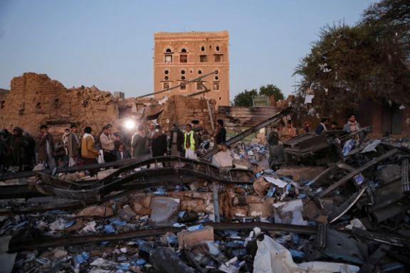 People stand at the site of US strikes in Sanaa, Yemen March 20, 2025.