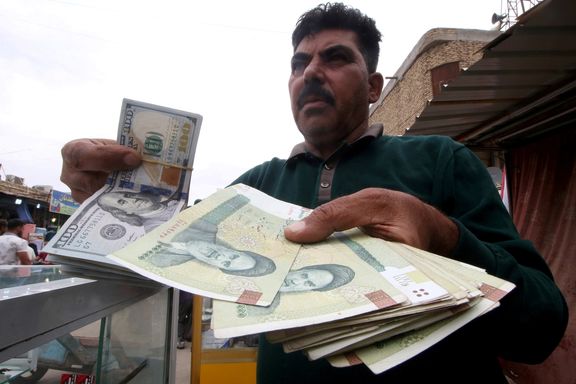 A man holds Iranian rials at a currency exchange shop in Basra, Iraq, November 3, 2018.