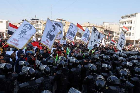 Protesters demonstrate against the dinar's slide in value, near the central bank in Baghdad, January 25, 2023