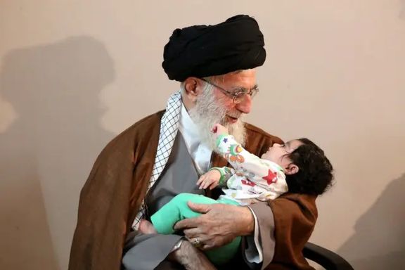 Supreme Leader Ali Khamenei holding a baby