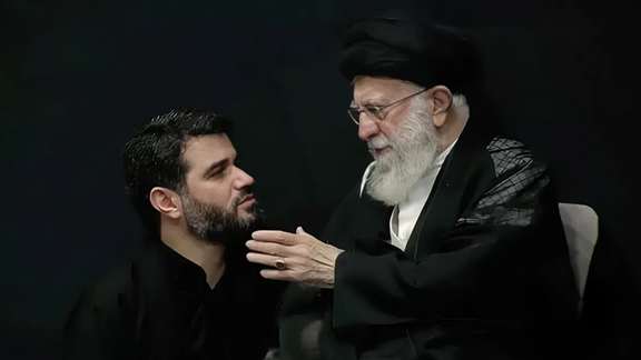 Meysam Motiee, a eulogist, (left) talking to Iran's Supreme Leader Ali Khamenei