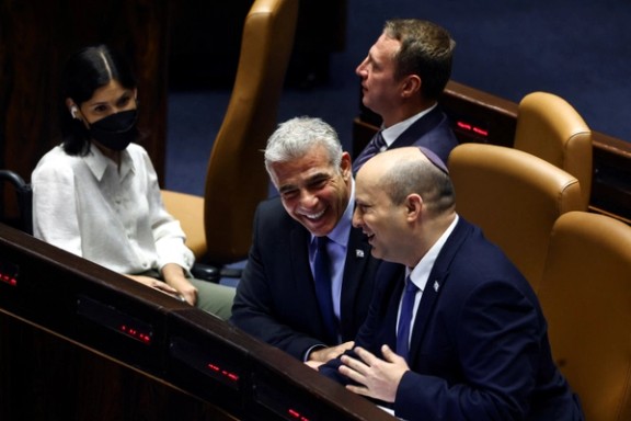 Lapid and Bennett joking in a Knesset meeting on June 30, 2022